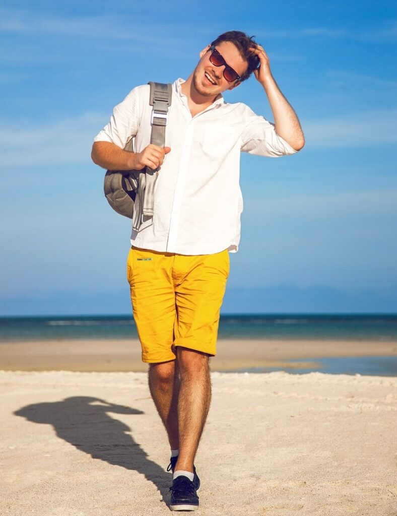 man bright trendy casual outfit walking tropical beach