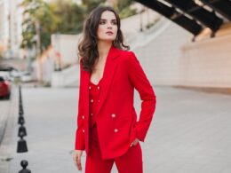 business woman in red Blazer walking in city street