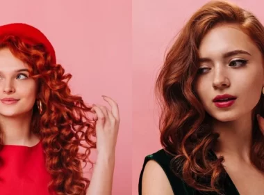 Two girls with red and black-red mix hair posing against a vibrant pink background.